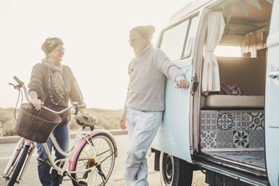 Senior couple outside van during vacation