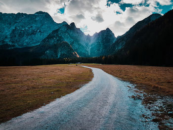 Road amidst mountains against sky