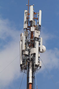 Low angle view of communications tower against sky