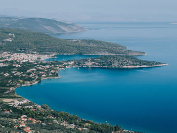 High angle view of city by sea against sky