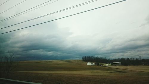 Scenic view of agricultural field against storm clouds