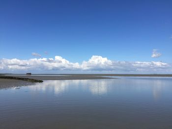 Scenic view of sea against blue sky