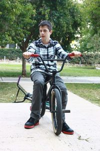 Full length of man riding bicycle in park