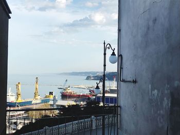 Commercial dock by sea against sky