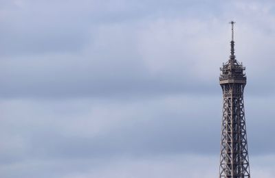 Low angle view of communications tower against sky