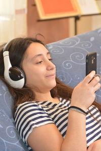 Portrait of young woman using mobile phone