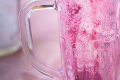 Close-up of leftover grape juice on drinking glass