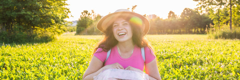 Portrait of happy woman on field