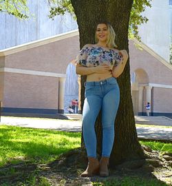 Full length of young woman standing in yard