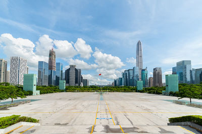 Buildings in city against cloudy sky