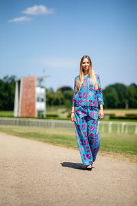 Full length of young woman standing outdoors