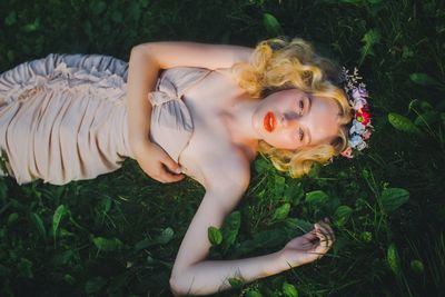 Young woman lying in grass