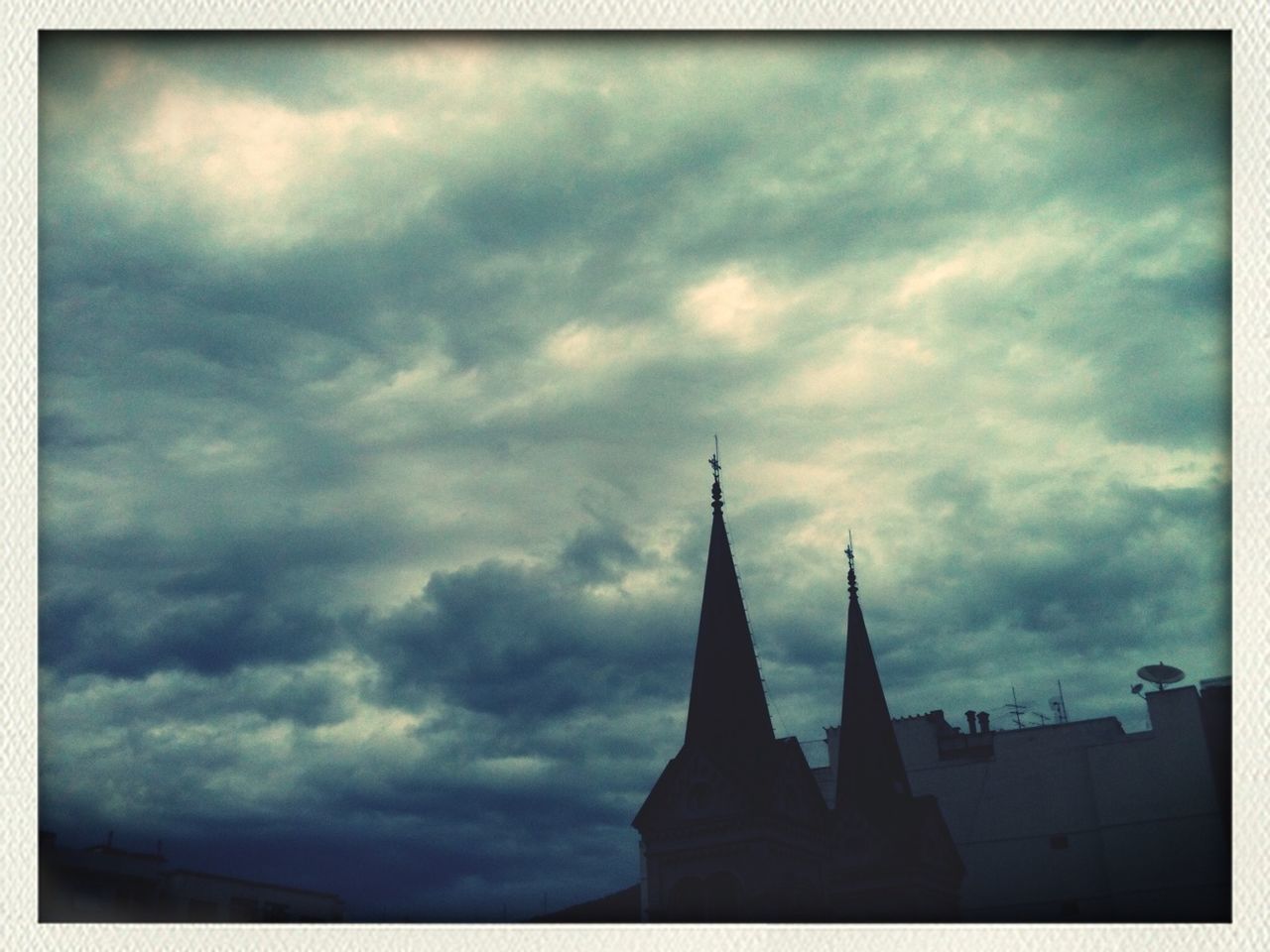 sky, architecture, built structure, cloud - sky, low angle view, building exterior, cloudy, transfer print, religion, place of worship, auto post production filter, spirituality, church, cloud, famous place, high section, silhouette, travel destinations, weather