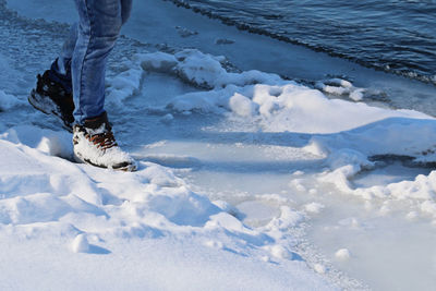 Low section of person on snow covered land