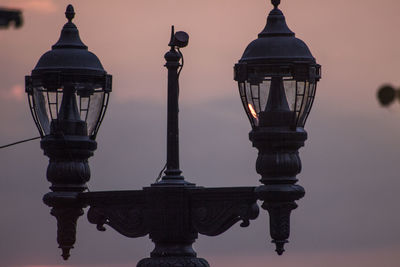 Close-up of street light against sky during sunset