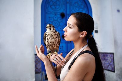 Young woman holding a falcon