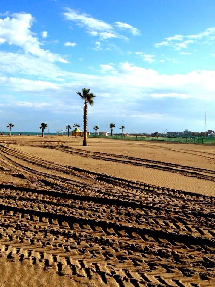 sky, sand, landscape, tranquility, tranquil scene, cloud - sky, cloud, desert, beach, nature, scenics, blue, tire track, sunlight, day, horizon over land, outdoors, remote, road, field