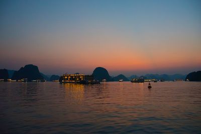 Scenic view of sea against clear sky at sunset