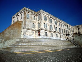 Low angle view of building against clear blue sky