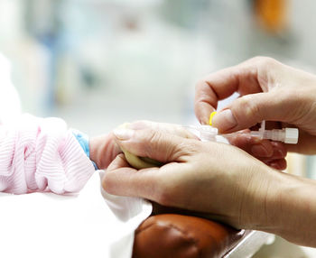 Doctor holding newborn baby in hospital