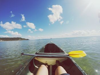 Low section of woman in canoe on sea