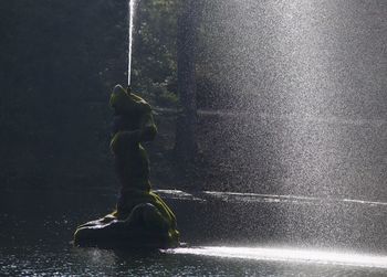 Water flowing from fountain in lake