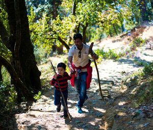 Child helping his father walk