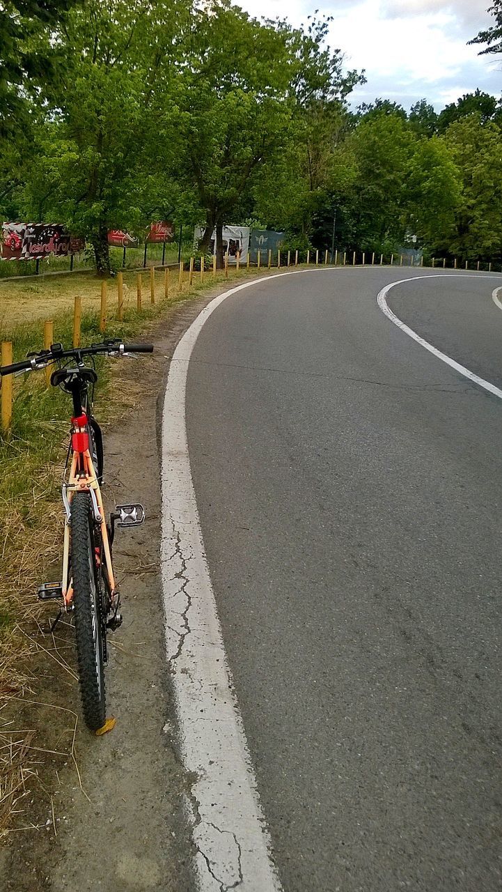 PERSON RIDING BICYCLE ON ROAD