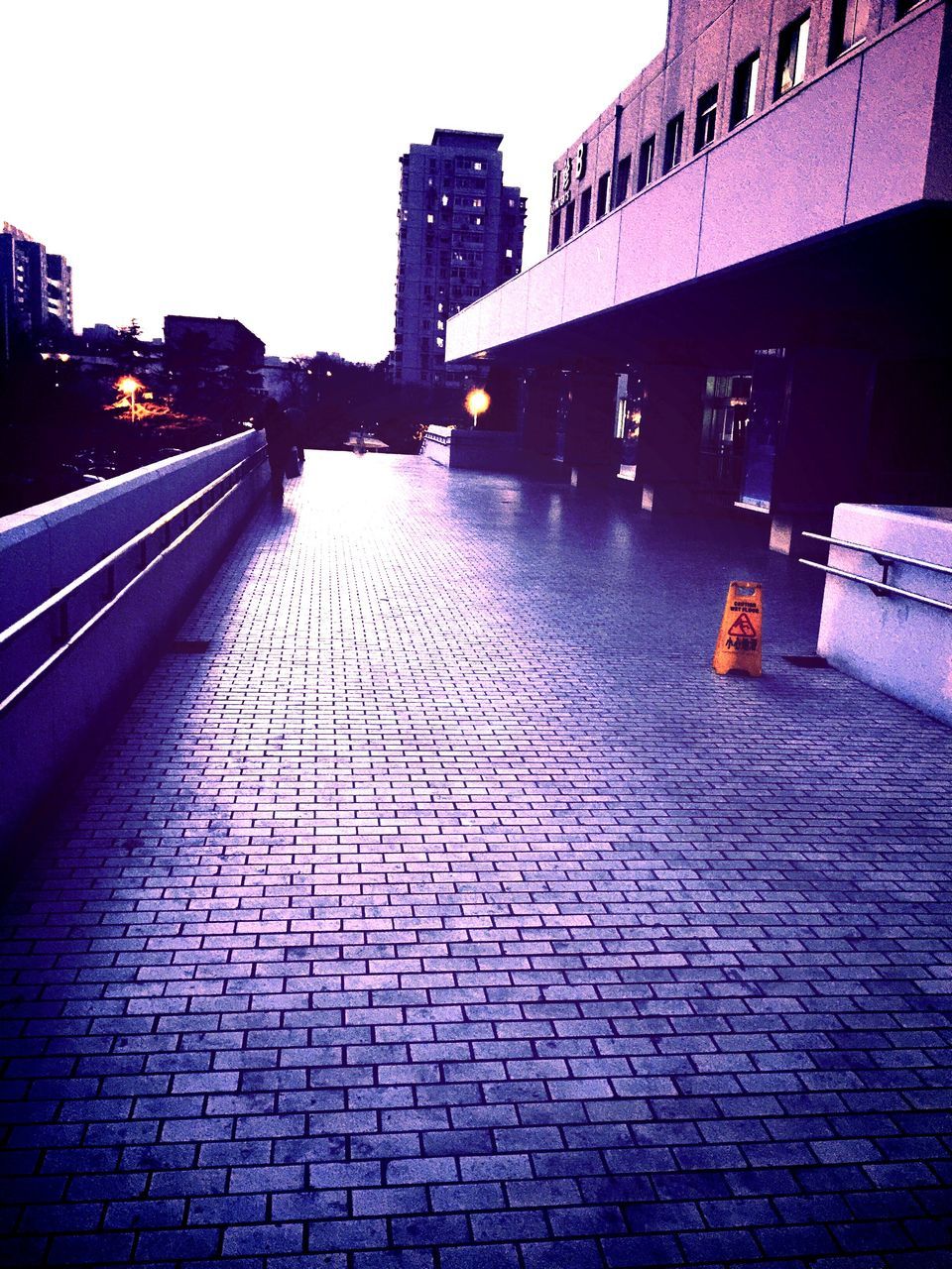 building exterior, architecture, built structure, cobblestone, city, the way forward, paving stone, street, building, diminishing perspective, water, sidewalk, walkway, sky, footpath, outdoors, surface level, clear sky, city life, reflection