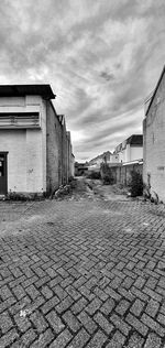 Houses by street against sky in city