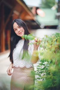 Portrait of young woman standing outdoors