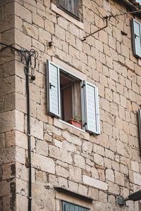 Low angle view of window on wall of building