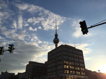 Low angle view of buildings against cloudy sky