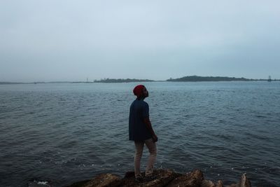 Rear view of woman standing in water