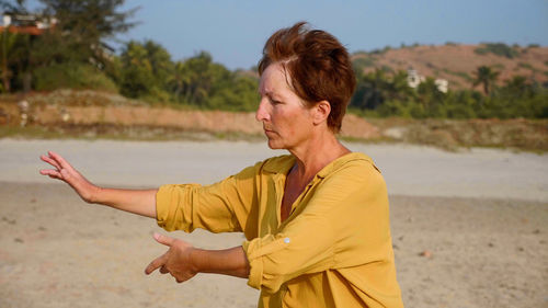 Side view of man standing at beach