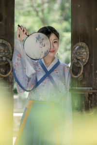 Portrait of young woman standing outdoors