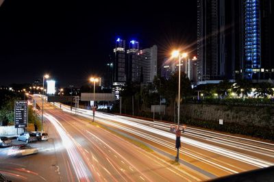 Illuminated road in city at night