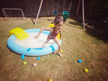 High angle view of girl playing in yard