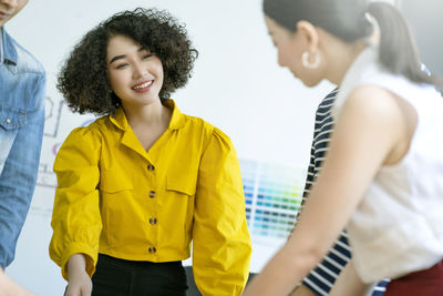 Smiling young woman standing with text