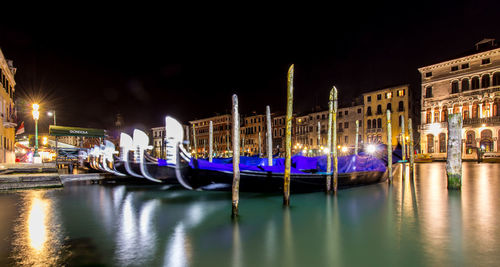 Gondolas moored in grand canal at night