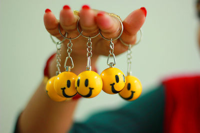 Close-up of hand holding yellow flowers
