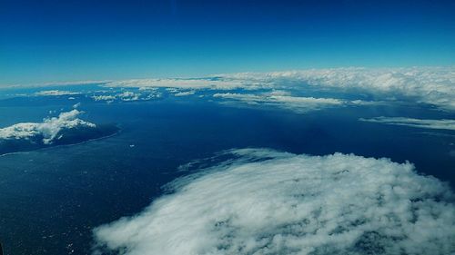 Aerial view of sea against blue sky