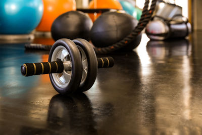 Closeup of a fitness equipment in gym. exercise wheel in a gym. fitness roller equipment.