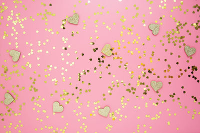 Low angle view of pink balloons against blue background