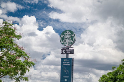 Low angle view of road sign against sky