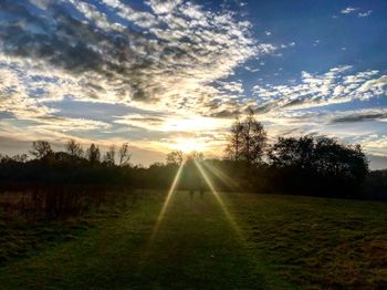 Scenic view of field against sky during sunset