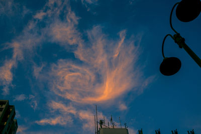 Low angle view of illuminated street light against sky