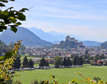 Buildings in a field with mountain range in the background