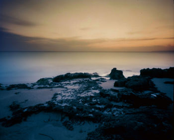 Scenic view of sea against sky at sunset