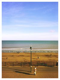 People walking on calm beach